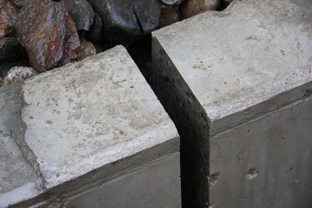 Slot cut in reinforced concrete drain with D1S diamond rocksaw on mini excavator